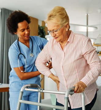 nurse guiding her patient in walking