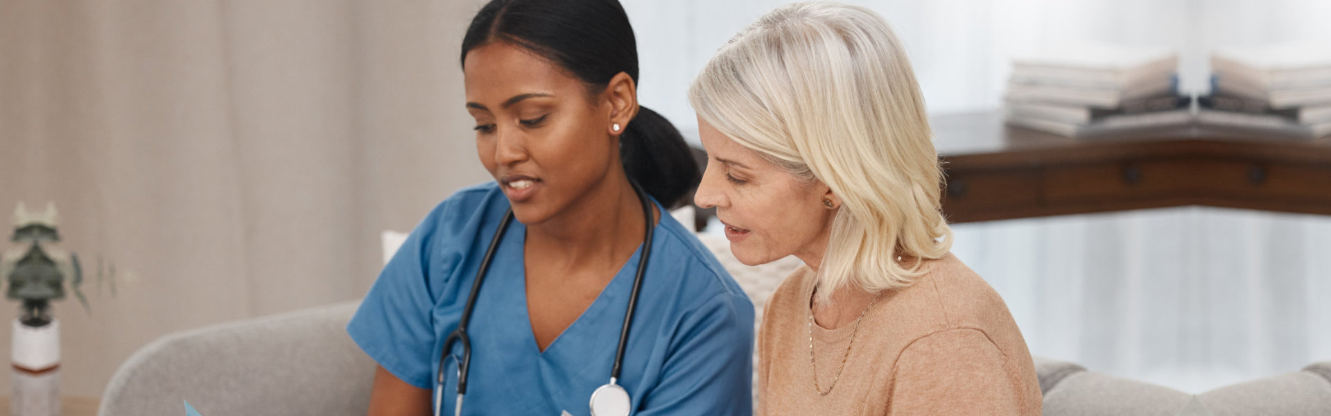 Elderly woman and female nurse with stethoscope