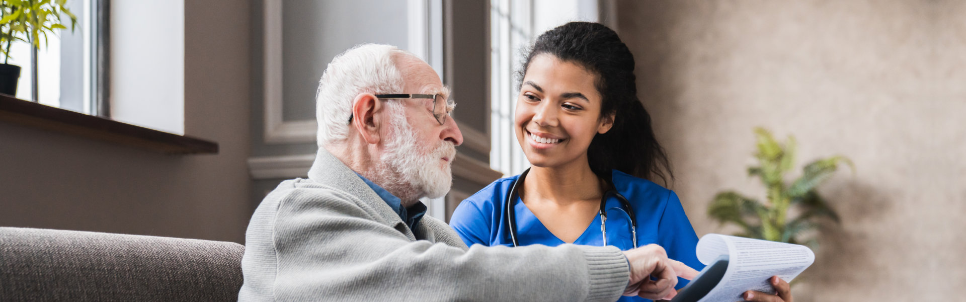 Elderly man and female nurse with stethoscope