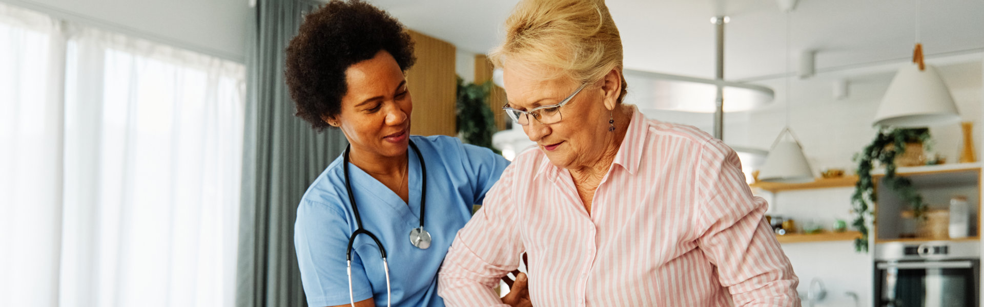 nurse guiding her patient in walking