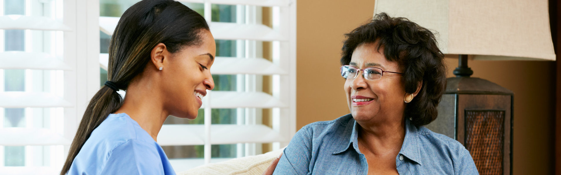 Elderly and female nurse talking